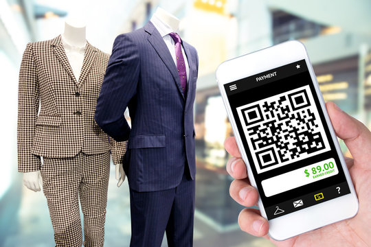 qr code payment technology , cashless concept. Customer use mobile phone to scan qrcode in retail fashion department store mall shop.