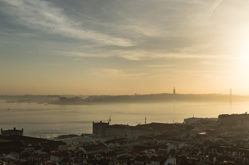 Views of Lisbon at sunset with mist in the horizon