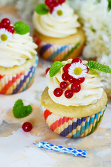 Gentle cupcake with cream and berries аnd a candle a light background