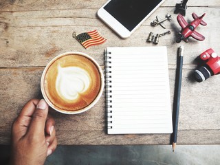 Woman drinking coffee cup with travel accessories