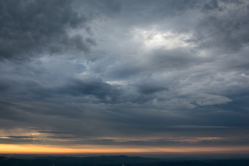 Fototapeta na wymiar Sky with dramatic clouds during a sunrise