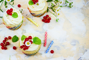 Gentle cupcake with cream and berries аnd a candle a light background