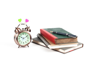 alarm clock with love heart sign and old book on isolate