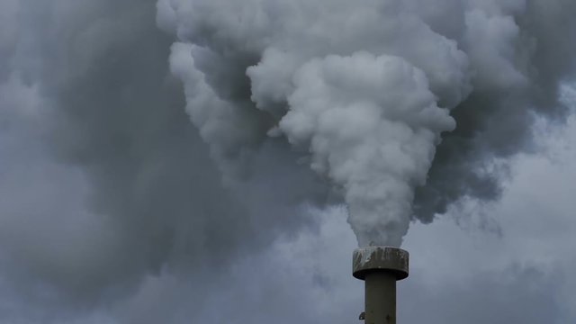 Billowing steam smoke stack filling sky, super slow motion close up side