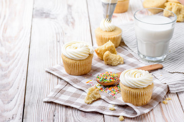 Tasty cupcakes on a white wooden table
