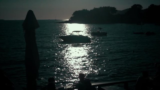 A silhouette of motor boat at sunset