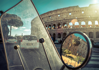 Retro scooter stay near the Roman Coliseum under blue sky with s © Andrii IURLOV