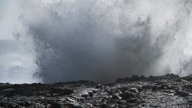 Huge explosive wave breaking on rocky coast Iceland slow motion