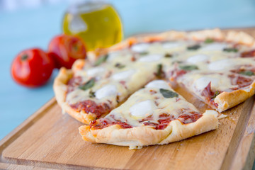 pizza with bacon, mozzarella on a blue background