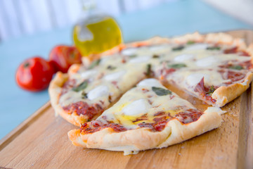 pizza with bacon, mozzarella on a blue background