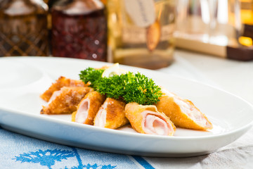 traditional Polish dishes. Front view of appetizing delicious meat snacks on a white plate. On the background different in the shape bottles with the oil