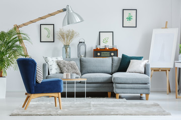 Blue armchair on grey carpet