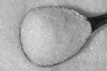 White Sugar. Picturing white sugar on a tea spoon.