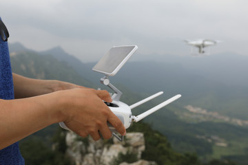 hands flying drone taking photo of the great wall landscape in China