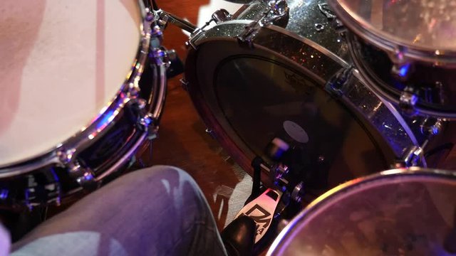 Jazz musician playing bass drum, pressing his foot on pedal, Live concert. Slow motion