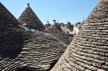 Fototapeta na wymiar Between trulli roofs the typical old houses in Alberobello, Apulia, Italy