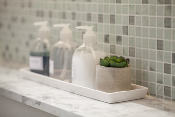Fototapeta na wymiar Liquid soap bottle with tile background Bathroom accessories.