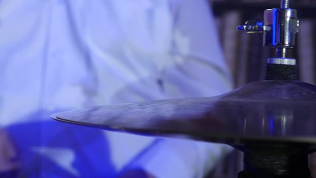 Male holds the drum sticks and playing on hi hat close up details.