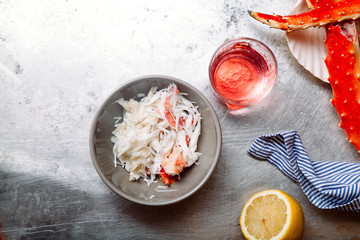 Cooked crab phalanx with aioli sauce and lemon slices on metallic background. Top view with copy space. © Anastasiia Nurullina