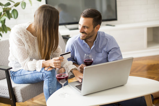 Cheerful couple searching internet and  shopping online
