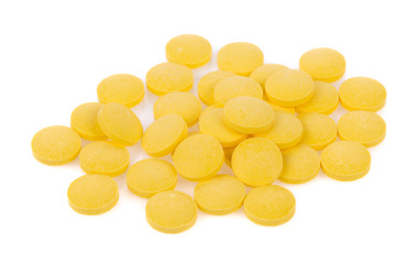 Yellow pills isolated on white background