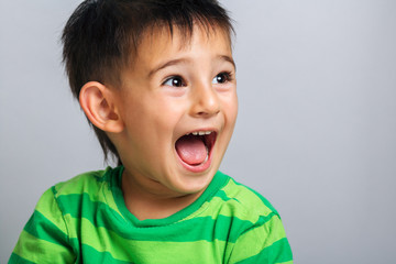 boy face, horizontal portrait of a caucasian child who happily laughing