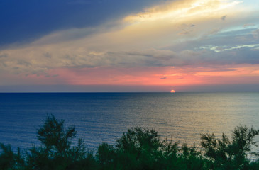 The setting sun over the sea