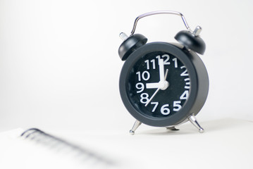 The black alarm clock has a white background.
