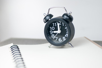 The black alarm clock has a white background.