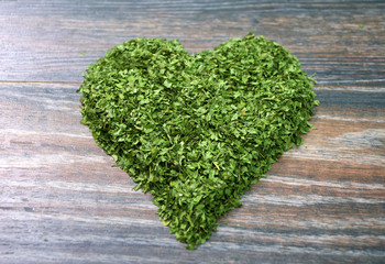 Various forms of parsley on a wooden background