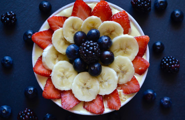Smoothie Bowl with Fresh Strawberries, Bananas and Blueberries.Heath Breakfast
