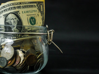 Saving money concept,  Dollar banknotes and coins in Glass Jar