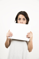 Fototapeta premium Beautiful young woman holding a blank sheet of paper