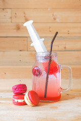 Italian red soda, Bloody Mary concept. Serve only during Halloween. Selective focus. red macarons