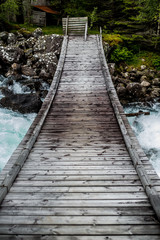 Wooden Bridge over a waterfall in National Park Norway