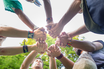 Crop people stacking hands during ritual