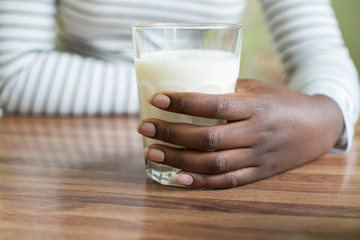 Close Up Of Teenage Girl Holding Glass Of Fresh Milk