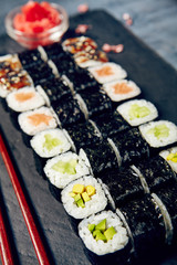 Menu of Japanese sushi rolls on black background