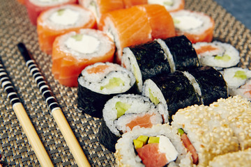 Menu of Japanese sushi rolls on black background