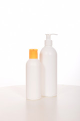 Cosmetics in bottles of plastic containers and tubes
