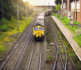 Fototapeta premium Freight train moves through the Trafford station.