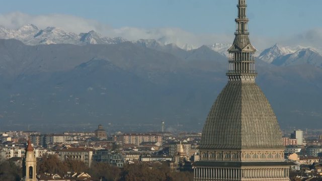 Mole Antonelliana major landmark building in Turin close up in a sunny morning in autumn with the snowy mountains in the background
