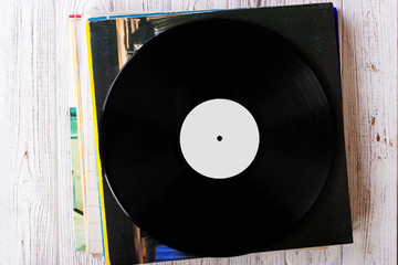Pile of old vinyl records on wooden background
