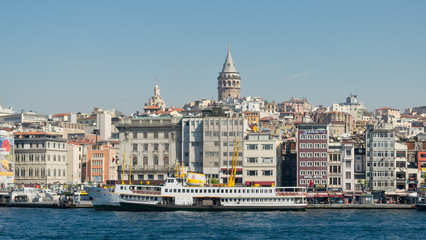 Fototapeta na wymiar City view of Istanbul, Turkey from the sea overlooking Galata Tower and Karakoy ferry terminal