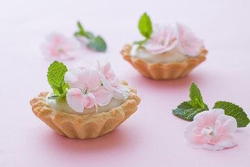 Mini tarts close up. Homemade dessert with delicious catalonian traditional cream and fresh flowers