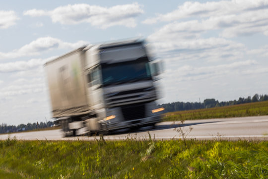Truck transport on the road with motion blur. Blurred image background. Colorful wallpaper with copy space