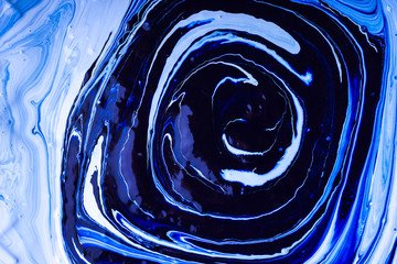 Abstract background. Paints. Fantastic patterns obtained by mixing blue paint white