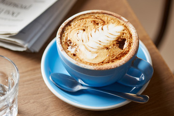 Beautiful blue cup of cappuccino.