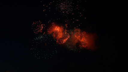 Beautiful red fireworks in dark black sky.