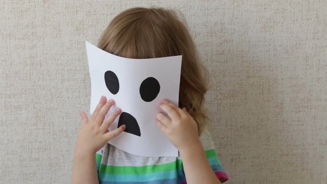 Conceptual portrait. Little child wearing a mask. smiley.
